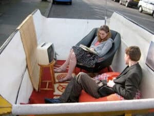 People sitting inside a trash can pretending to work.