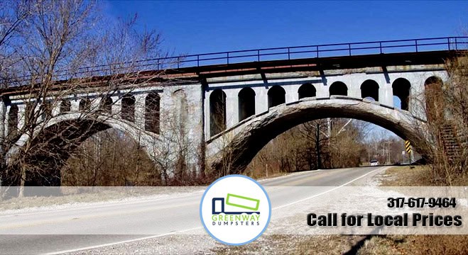 Greenway Dumpster Rentals logo on a marketing image with a bridge in the background.