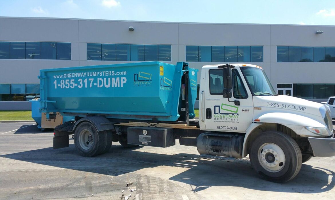 A clean Greenway dumpster on the back of a truck.