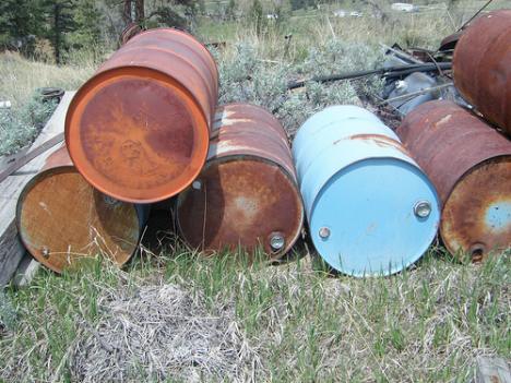 Rusted barrels left over from debris on a job site.