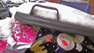 A dumpster filled with discarded Christmas decorations.