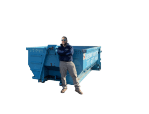 Jordan standing in front of a 10-yard dumpster for size reference.