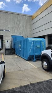 A dumpster compactor unit located in the city of Indianapolis.