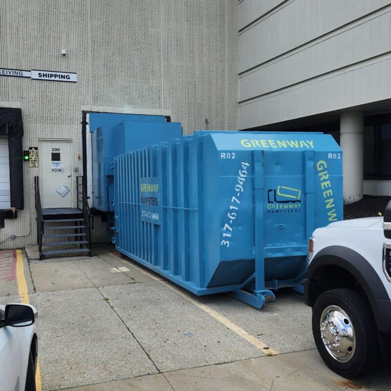 A dumpster compactor unit located in the city of Indianapolis.