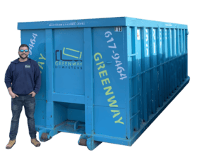 Jordan standing next to another 40-yard dumpster for size reference.
