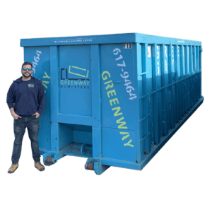 Jordan standing in front of a 40-yard dumpster for size comparison.